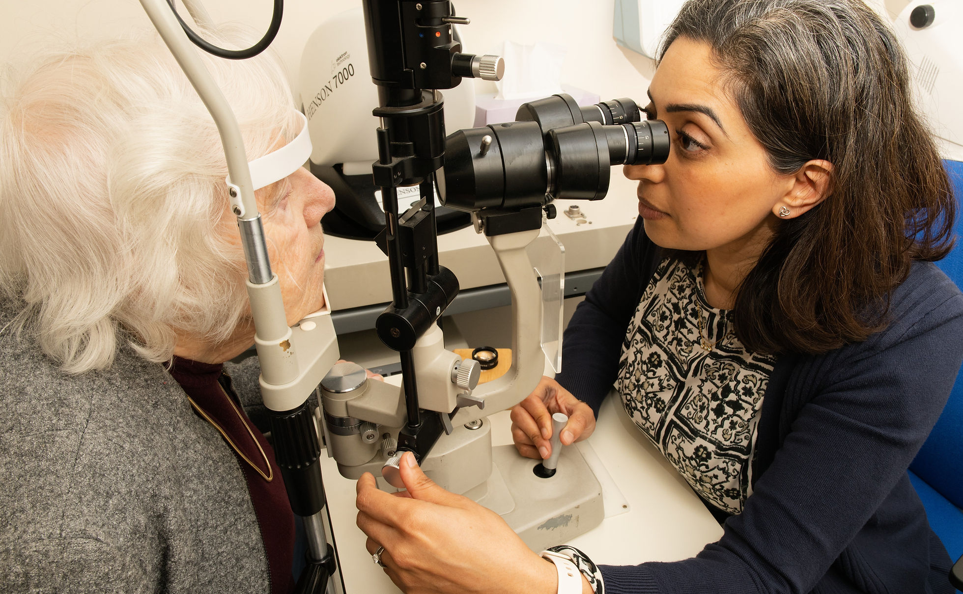 Sonya Gandhi performing a slit lamp eye examination